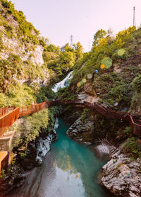 High angle view of river amidst trees against sky