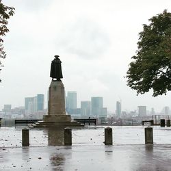 Statue by sea against sky