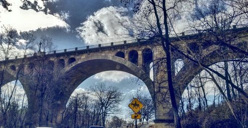 Low angle view of arch bridge against sky