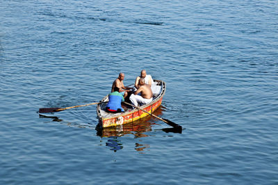 High angle view of people sitting on boat in sea