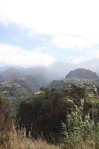 Scenic view of mountains against cloudy sky