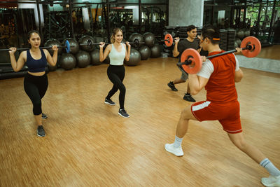 Low section of woman exercising in gym