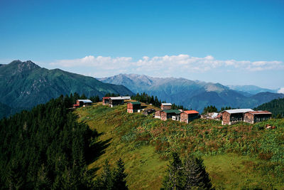 Scenic view of houses and trees against sky