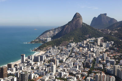 High angle view of cityscape by sea against sky