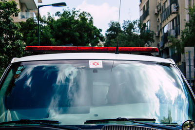 Red car on street in city