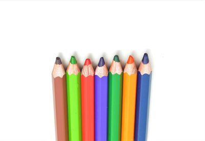 Close-up of colored pencils against white background