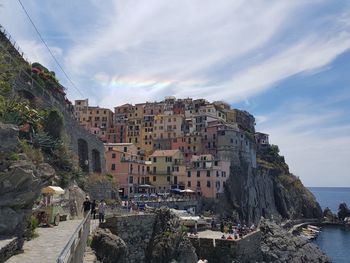 Panoramic view of buildings and sea against sky