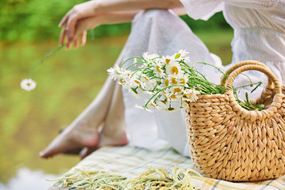 Midsection of woman holding bouquet