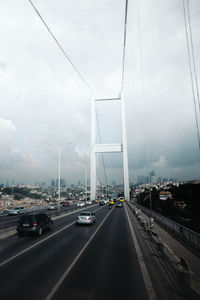 Traffic on highway in city against sky