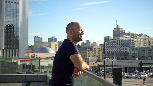 Full length of man standing in city against sky