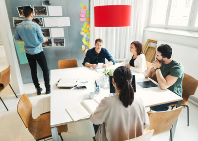 Team of business people discussing project at conference table in office