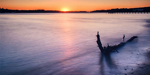 Scenic view of lake against sky during sunset