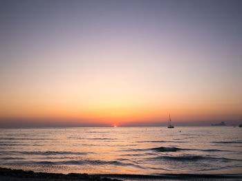 Scenic view of sea against clear sky during sunset