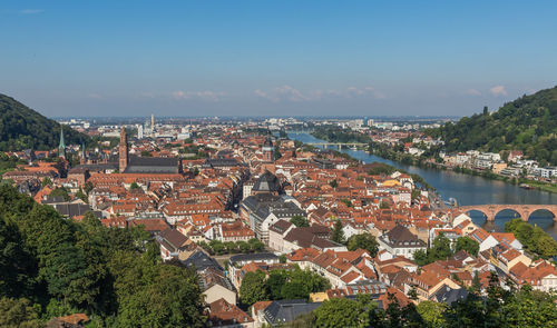 High angle view of townscape and river against sky