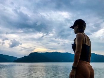 Woman standing by lake 