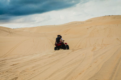 Man riding motorcycle in desert