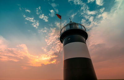 Low angle view of lighthouse against sky during sunset