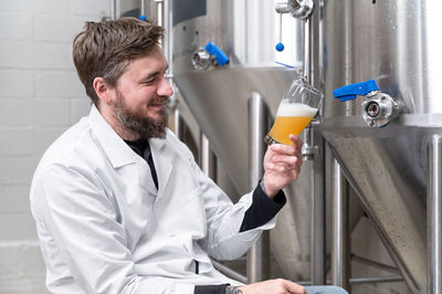 Side view of man drinking glass