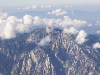 Aerial view of snowcapped mountains against sky