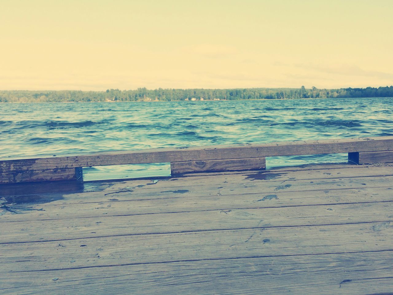 water, sea, pier, tranquil scene, tranquility, scenics, railing, beauty in nature, nature, sky, built structure, clear sky, copy space, jetty, idyllic, rippled, lake, wood - material, architecture, calm