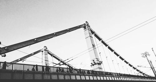 Low angle view of cranes against clear sky