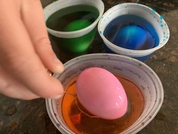 Midsection of person holding multi colored candies