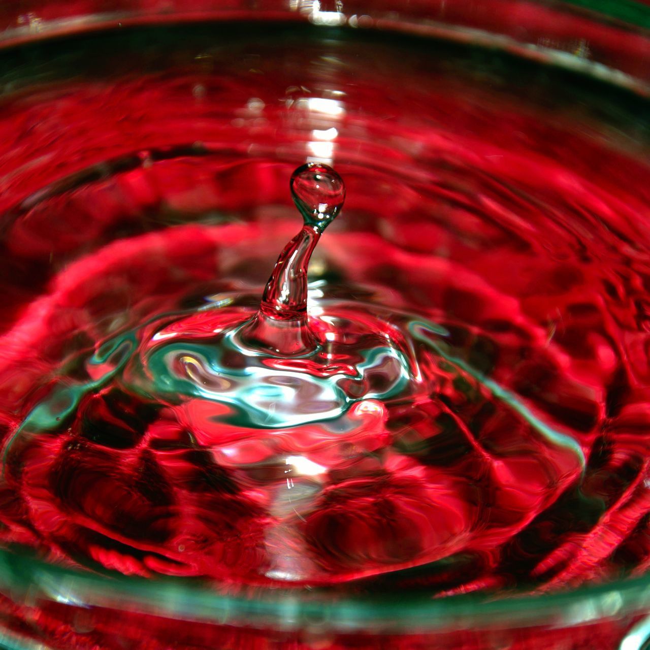 red, close-up, water, indoors, motion, drop, selective focus, purity, high angle view, freshness, transparent, still life, shiny, detail, rippled, pattern, no people, full frame, reflection, backgrounds