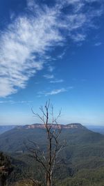 Scenic view of mountains against blue sky