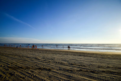 Scenic view of beach against blue sky