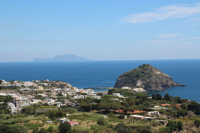 Scenic view of sea and mountains against sky