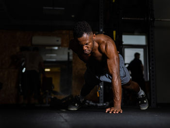 Side view of man exercising in gym