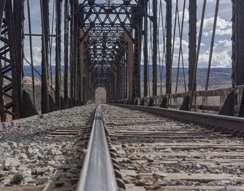 Surface level of railroad tracks against sky