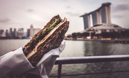 Close-up of sandwich by river in city