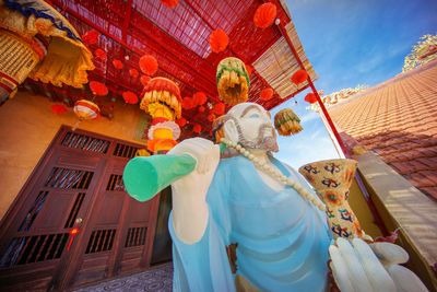 Rear view of woman standing against temple