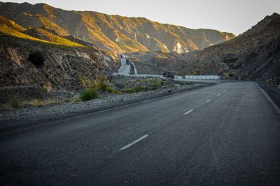 Empty road by mountain