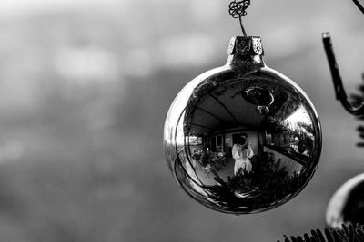 Close-up of christmas decorations hanging on metal