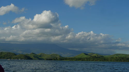 Scenic view of lake and mountains against sky