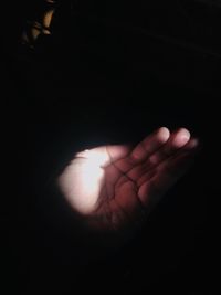 Close-up of human hand against sunlight