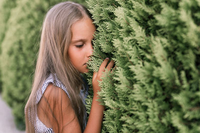 Portrait face of candid offended upset little kid girl of eight years old with long blond hair 