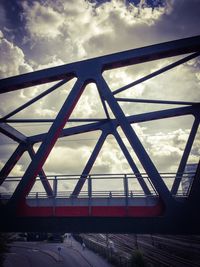 Bridge over river against cloudy sky