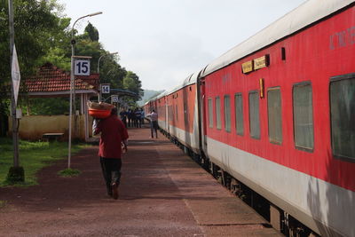 Man walking on train against sky