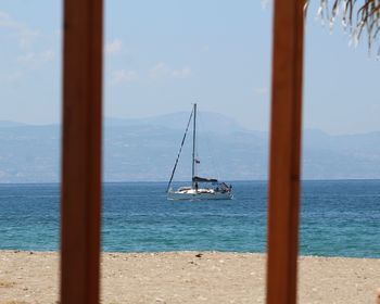 Sailboat on sea against sky