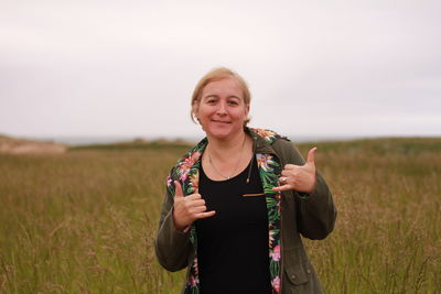 Portrait of smiling woman standing on field