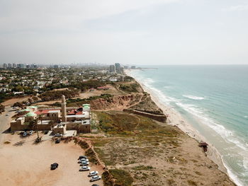 High angle view of sea and buildings against sky