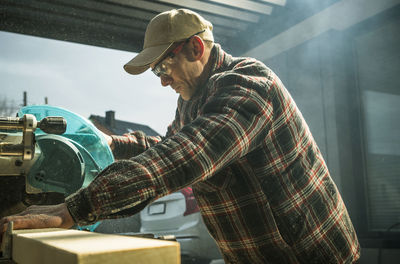 Side view of man working at construction site