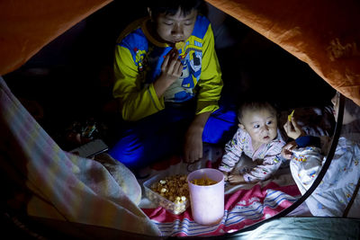 High angle view of children sitting in tent