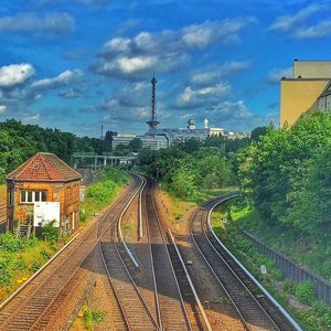 Railroad track against cloudy sky