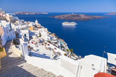 High angle view of buildings by sea against sky