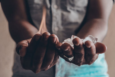 Midsection of man holding ice