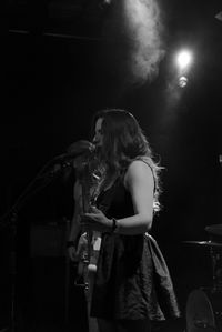 Young woman playing in music concert